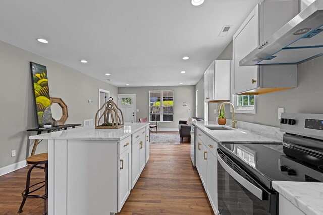 2001 Vine St, Chattanooga, TN 37404 - kitchen with stainless steel electric range oven, extractor fan, dark wood-style flooring, recessed lighting, and a kitchen island