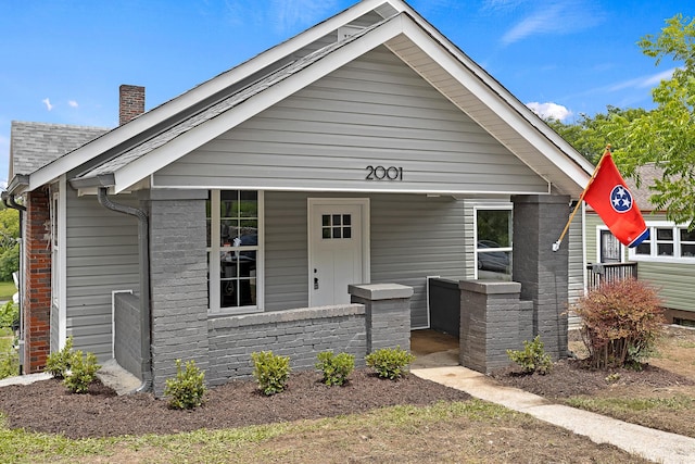 2001 Vine St, Chattanooga, TN 37404 - view of front of house featuring a chimney, brick siding, and roof with shingles