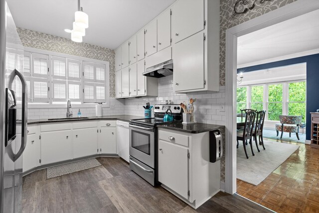 100 Scenic Hwy Unit 49, Lookout Mountain, TN 37350 - kitchen with stainless steel appliances, under cabinet range hood, dark countertops, healthy amount of natural light, and wallpapered walls