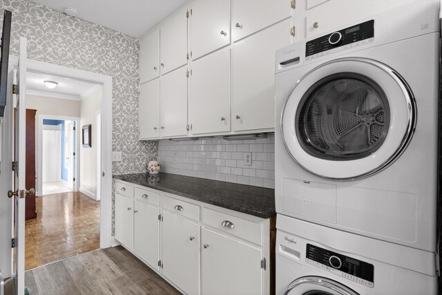 100 Scenic Hwy Unit 49, Lookout Mountain, TN 37350 - washroom with cabinet space, wallpapered walls, stacked washer / drying machine, wood finished floors, and ornamental molding