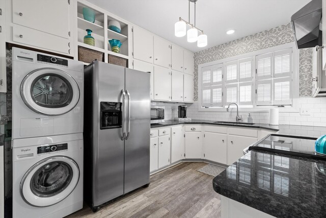 100 Scenic Hwy Unit 49, Lookout Mountain, TN 37350 - kitchen with stainless steel appliances, stacked washer / drying machine, decorative backsplash, light wood-style floors, and recessed lighting