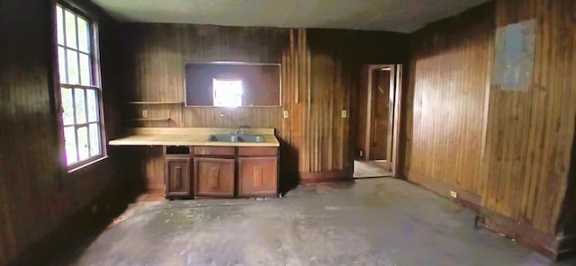 207 W 9th St, Chickamauga, GA 30707 - kitchen with wood walls, light countertops, unfinished concrete floors, open shelves, and brown cabinetry