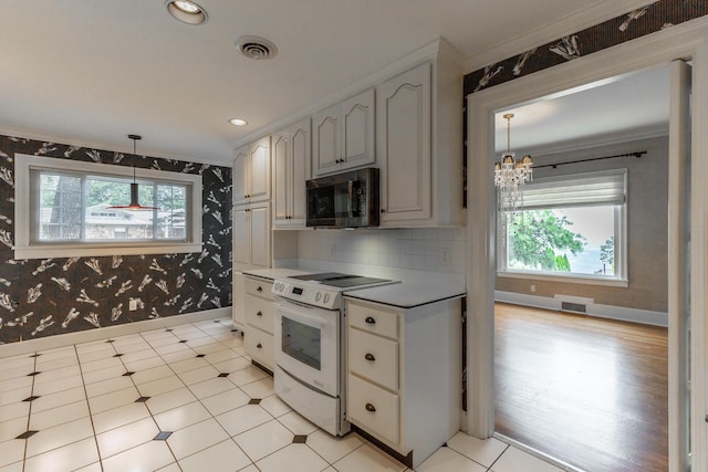 208 S Palisades Dr, Signal Mountain, TN 37377 - kitchen with black microwave, electric stove, wallpapered walls, crown molding, and a chandelier