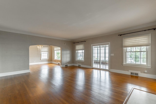 208 S Palisades Dr, Signal Mountain, TN 37377 - spare room featuring arched walkways, wood finished floors, ornamental molding, and a chandelier
