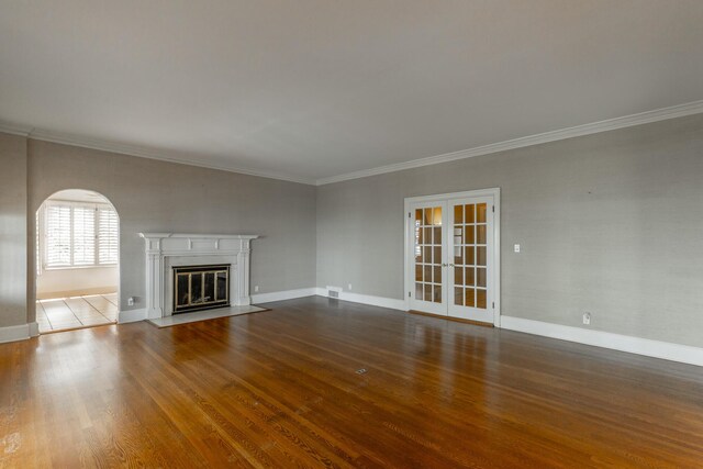 208 S Palisades Dr, Signal Mountain, TN 37377 - unfurnished living room with wood finished floors, a fireplace with flush hearth, crown molding, and french doors