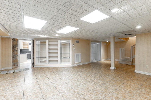 208 S Palisades Dr, Signal Mountain, TN 37377 - spare room with built in shelves, stairway, light tile patterned flooring, and wood walls
