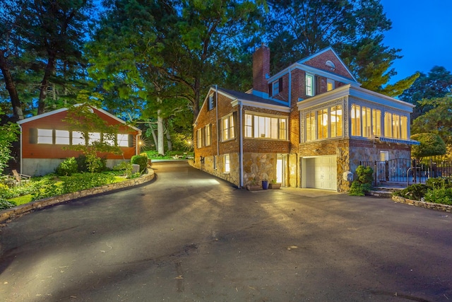 208 S Palisades Dr, Signal Mountain, TN 37377 - view of front of home featuring a chimney, stone siding, a garage, asphalt driveway, and brick siding
