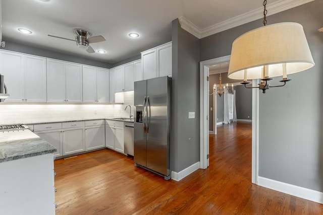 802 Signal Mountain Blvd Unit 121, Signal Mountain, TN 37377 - kitchen featuring appliances with stainless steel finishes, tasteful backsplash, a chandelier, light stone countertops, and ornamental molding