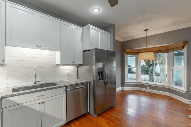 802 Signal Mountain Blvd Unit 121, Signal Mountain, TN 37377 - kitchen featuring stainless steel appliances, light stone countertops, backsplash, crown molding, and light wood-type flooring