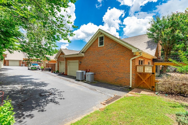 802 Signal Mountain Blvd Unit 121, Signal Mountain, TN 37377 - view of home's exterior featuring a garage, roof with shingles, and brick siding