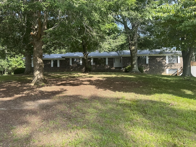 30551 Al Al Unit 71, Bryant, AL 35958 - view of front of home featuring a front yard, a metal roof, driveway, and brick siding