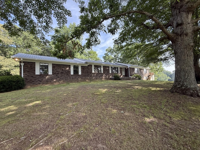 30551 Al Al Unit 71, Bryant, AL 35958 - single story home with brick siding, a metal roof, a front yard, and a standing seam roof