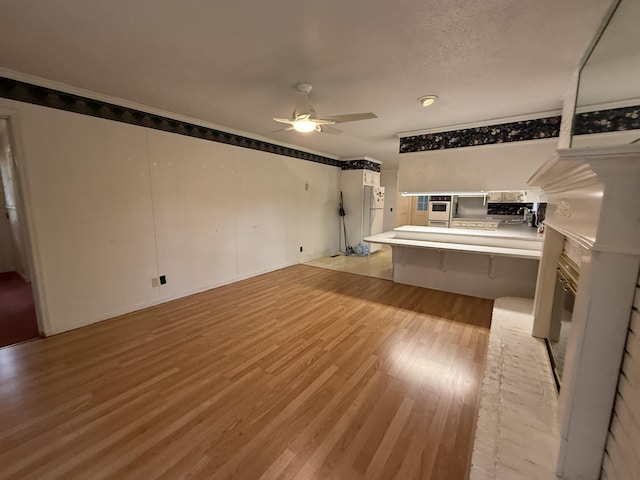 30551 Al Al Unit 71, Bryant, AL 35958 - unfurnished living room with light wood finished floors, ceiling fan, and ornamental molding