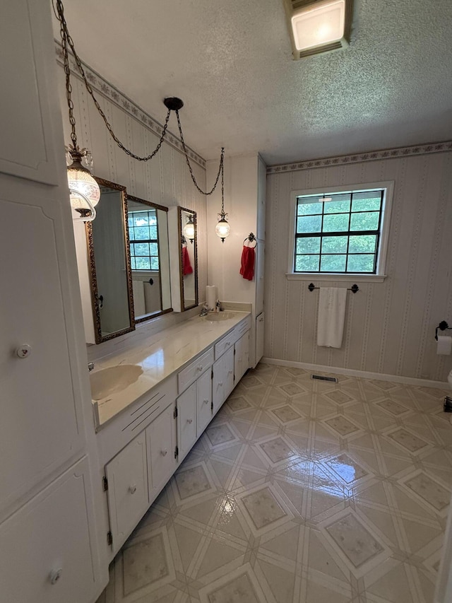 30551 Al Al Unit 71, Bryant, AL 35958 - bathroom with a textured ceiling, double vanity, and wallpapered walls