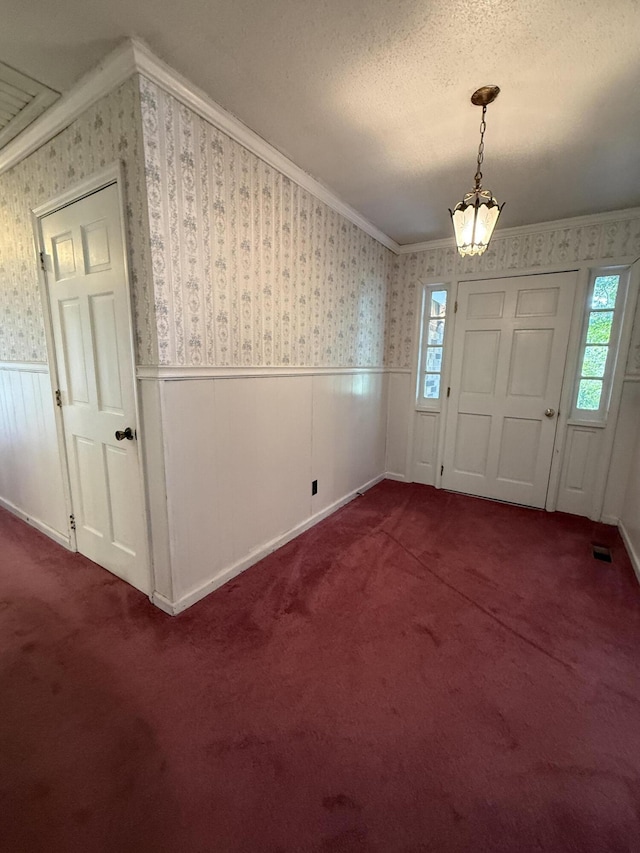 30551 Al Al Unit 71, Bryant, AL 35958 - carpeted foyer featuring wallpapered walls, a wainscoted wall, crown molding, healthy amount of natural light, and a textured ceiling