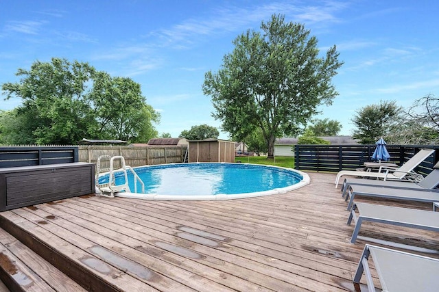414 N Three Notch Rd, Ringgold, GA 30736 - view of pool featuring a wooden deck, a storage unit, and a fenced backyard
