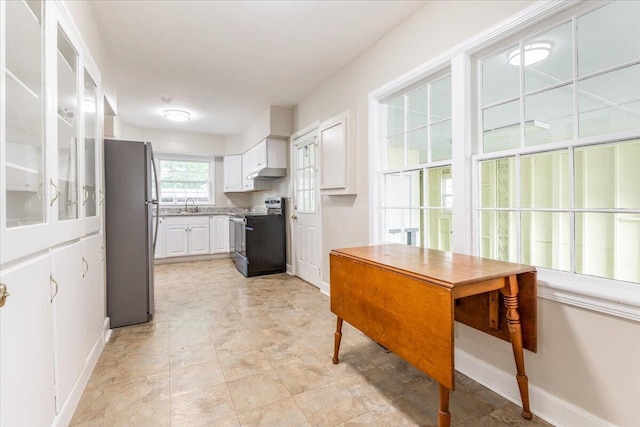 147 Kirby St, Summerville, GA 30747 - kitchen with appliances with stainless steel finishes, white cabinetry, under cabinet range hood, and light countertops