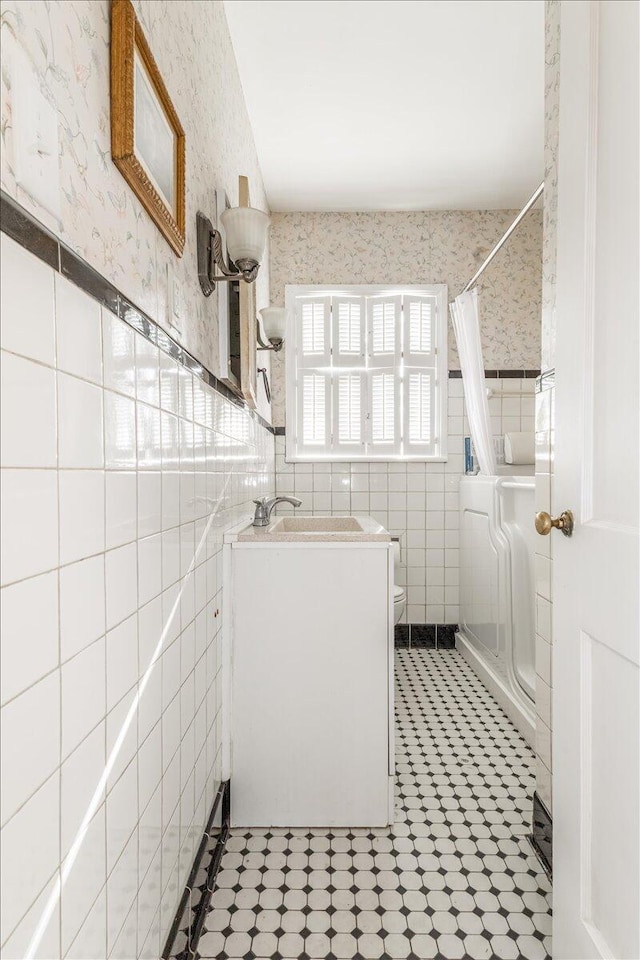 147 Kirby St, Summerville, GA 30747 - full bath featuring wallpapered walls, tile walls, a shower with curtain, vanity, and wainscoting