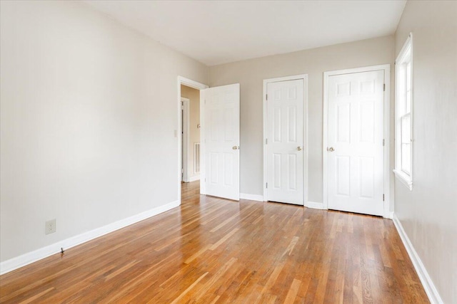 147 Kirby St, Summerville, GA 30747 - unfurnished bedroom featuring light wood-style flooring and multiple windows