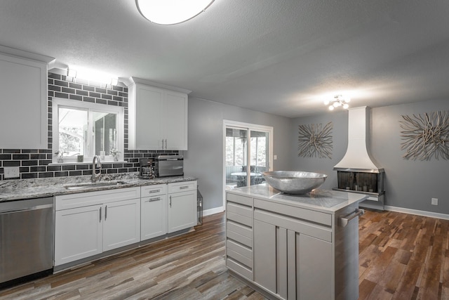 409 Caraway Turn, Chattanooga, TN 37415 - kitchen with dishwasher, backsplash, wood finished floors, white cabinetry, and a textured ceiling