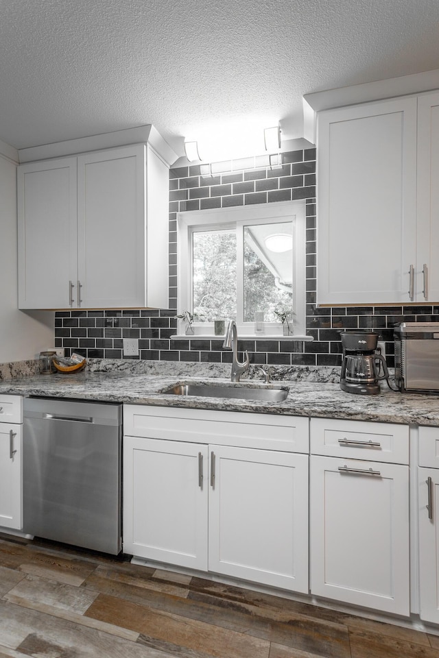 409 Caraway Turn, Chattanooga, TN 37415 - kitchen with dishwasher, tasteful backsplash, white cabinetry, a textured ceiling, and light stone countertops