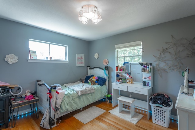 409 Caraway Turn, Chattanooga, TN 37415 - bedroom with multiple windows, wood finished floors, and a chandelier