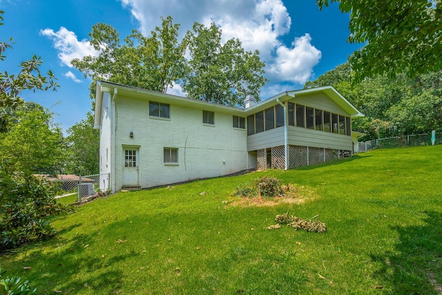 409 Caraway Turn, Chattanooga, TN 37415 - back of property featuring a sunroom, a chimney, and brick siding