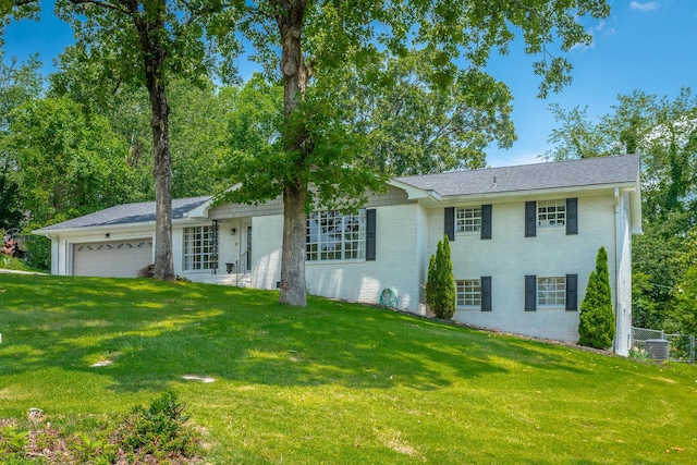 409 Caraway Turn, Chattanooga, TN 37415 - view of front facade with an attached garage, brick siding, and a front yard