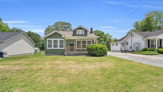 1514 Prigmore Rd, Chattanooga, TN 37412 - bungalow-style house with a porch, a chimney, a front lawn, and concrete driveway