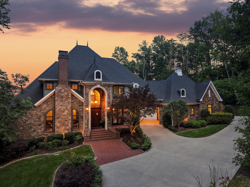 11606 Channel Front Ct, Soddy Daisy, TN 37379 - french country inspired facade with a chimney, stone siding, and curved driveway