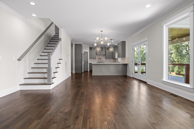 1784 River Breeze Dr, Soddy Daisy, TN 37379 - unfurnished living room featuring ornamental molding, a chandelier, stairs, dark wood-type flooring, and recessed lighting