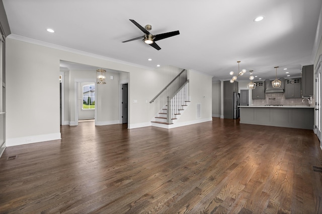 1784 River Breeze Dr, Soddy Daisy, TN 37379 - unfurnished living room featuring a chandelier, ornamental molding, recessed lighting, stairway, and ceiling fan