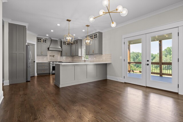 1784 River Breeze Dr, Soddy Daisy, TN 37379 - kitchen with gray cabinetry, wall chimney exhaust hood, a peninsula, appliances with stainless steel finishes, and a chandelier