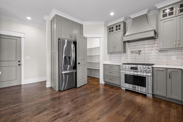 1784 River Breeze Dr, Soddy Daisy, TN 37379 - kitchen with stainless steel appliances, gray cabinetry, custom exhaust hood, light countertops, and ornamental molding