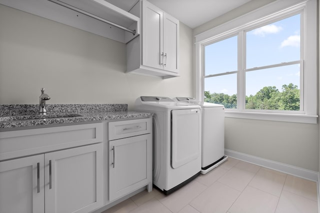 1784 River Breeze Dr, Soddy Daisy, TN 37379 - washroom featuring washing machine and dryer, cabinet space, and light tile patterned flooring