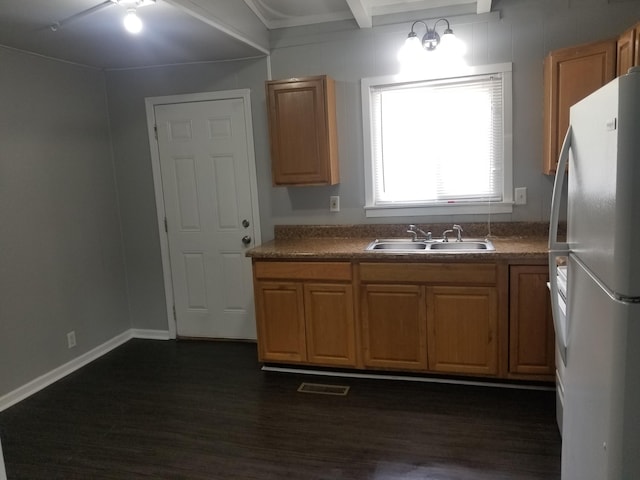 5007 Jarrett Rd, Chattanooga, TN 37416 - kitchen featuring freestanding refrigerator, dark wood finished floors, beamed ceiling, and brown cabinetry