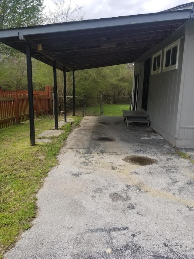 5007 Jarrett Rd, Chattanooga, TN 37416 - view of parking featuring entry steps, asphalt driveway, an attached carport, and a gate