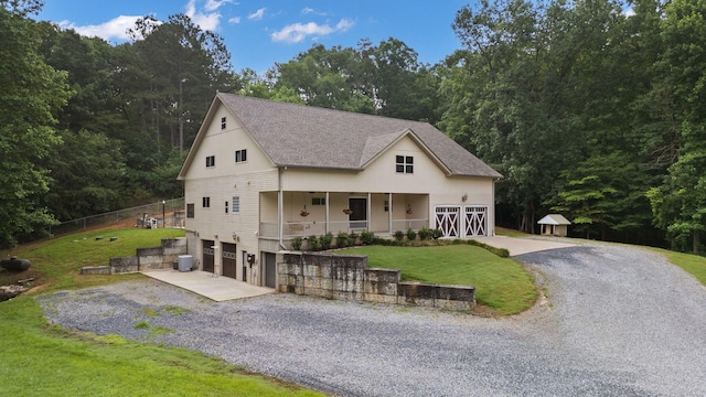 210 Gordon Dr, Chatsworth, GA 30705 - view of front of property featuring driveway, a front lawn, a garage, roof with shingles, and a porch