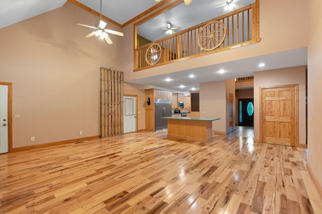 210 Gordon Dr, Chatsworth, GA 30705 - unfurnished living room featuring high vaulted ceiling, a ceiling fan, and light wood-style flooring