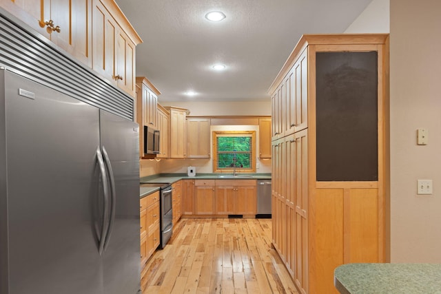 210 Gordon Dr, Chatsworth, GA 30705 - kitchen featuring stainless steel appliances, light wood-type flooring, light brown cabinets, recessed lighting, and a textured ceiling