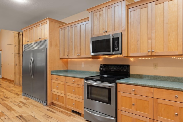 210 Gordon Dr, Chatsworth, GA 30705 - kitchen featuring stainless steel appliances, light wood-style floors, light brown cabinets, and dark countertops