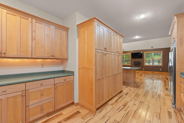 210 Gordon Dr, Chatsworth, GA 30705 - kitchen with light brown cabinetry, light wood-type flooring, stainless steel fridge, and recessed lighting
