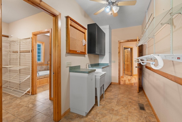 210 Gordon Dr, Chatsworth, GA 30705 - laundry room featuring a ceiling fan and cabinet space