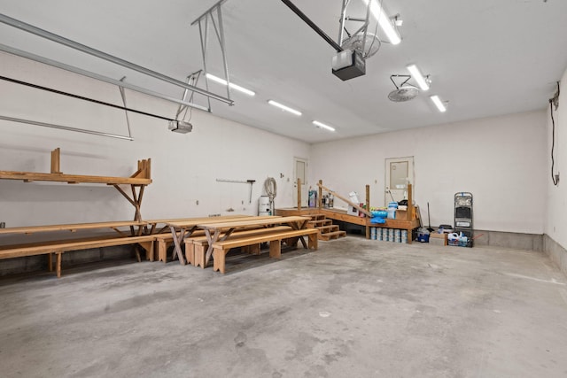 210 Gordon Dr, Chatsworth, GA 30705 - garage featuring a garage door opener and a workshop area