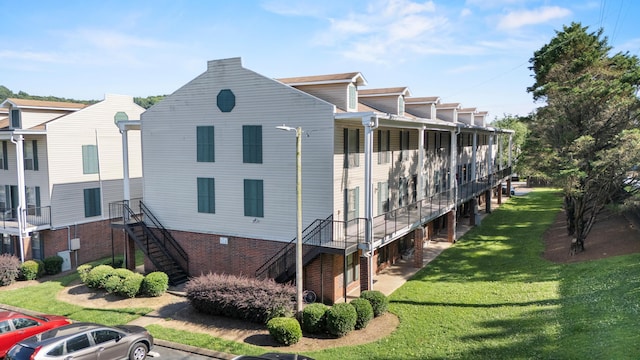 900 Mountain Creek Rd Unit E66, Chattanooga, TN 37405 - view of side of home with stairway, a yard, and uncovered parking