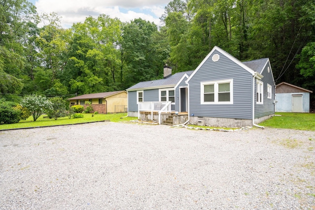 1006 Shallowford Rd, Chattanooga, TN 37411 - view of front facade featuring a shed, a chimney, a deck, crawl space, and driveway