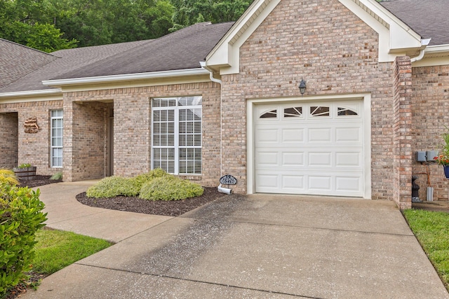6276 Amber Brook Dr, Hixson, TN 37343 - view of front facade featuring concrete driveway, roof with shingles, a garage, and brick siding