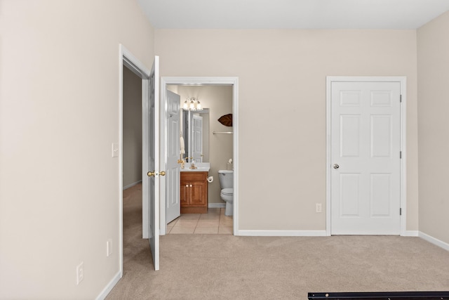6276 Amber Brook Dr, Hixson, TN 37343 - unfurnished bedroom with light carpet, light tile patterned flooring, and connected bathroom