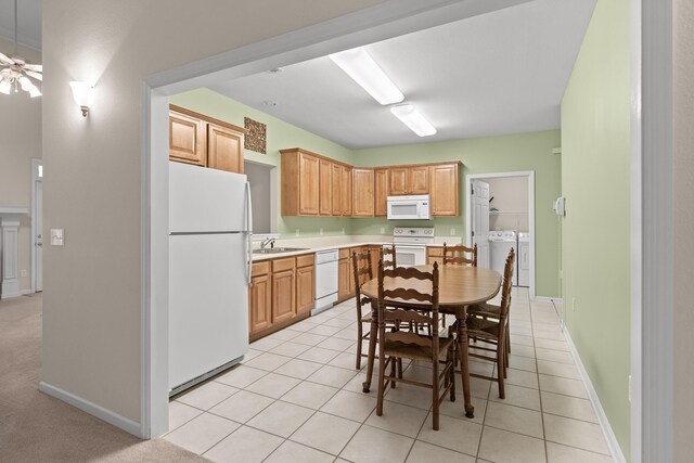 6276 Amber Brook Dr, Hixson, TN 37343 - kitchen with white appliances, washer and clothes dryer, light countertops, a ceiling fan, and light tile patterned floors