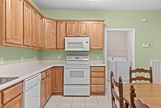 6276 Amber Brook Dr, Hixson, TN 37343 - kitchen featuring white appliances, separate washer and dryer, light countertops, and light tile patterned floors